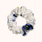 White scrunchie with blue and yellow pattern on a white background
