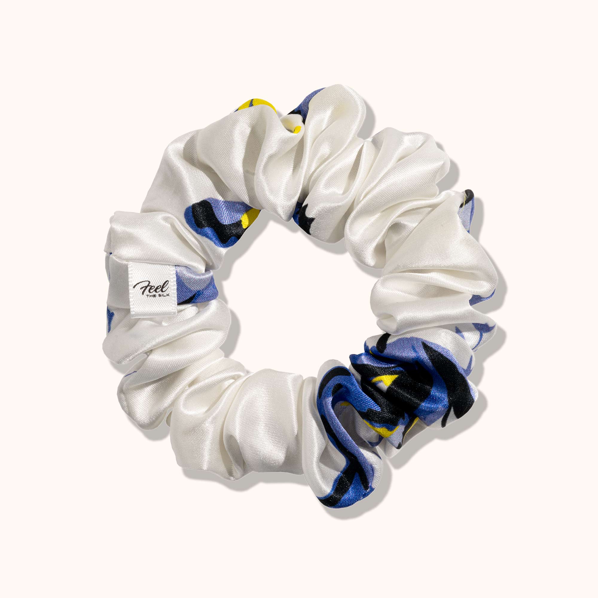 White scrunchie with blue and yellow pattern on a white background